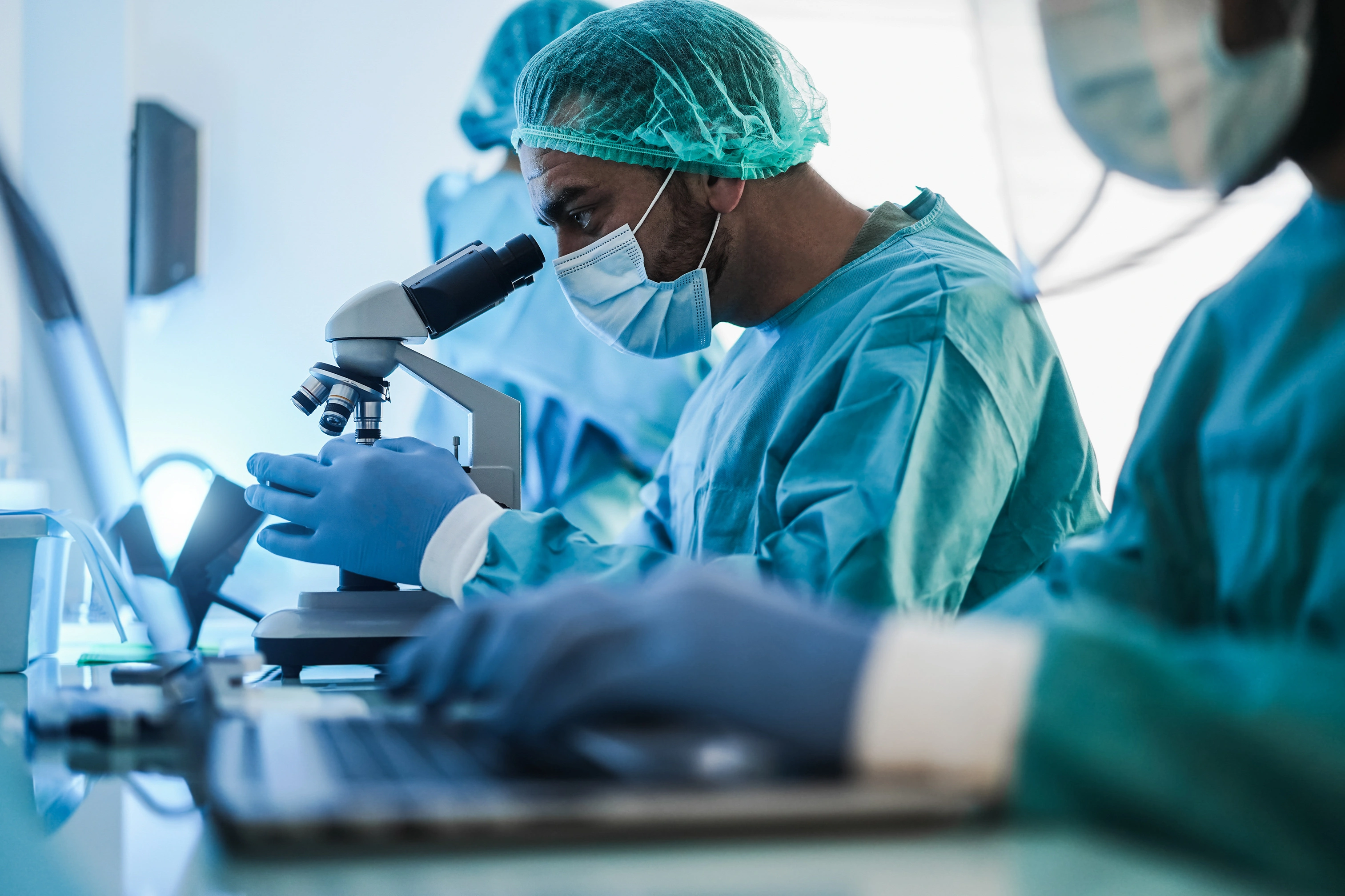 Lab technicians using microscope